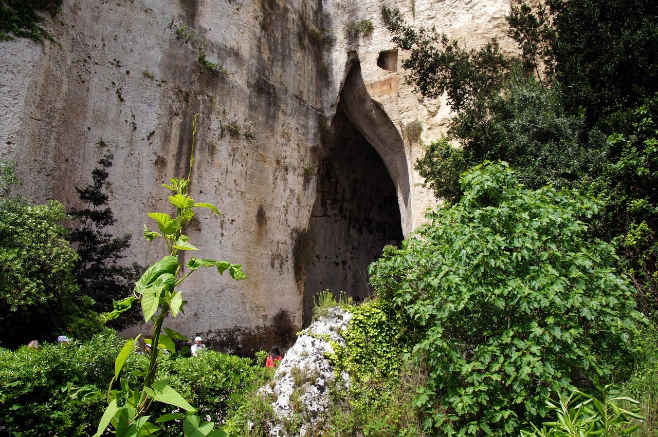 Visitatori esplorano le suggestive Grotte di Rescia immerse nella natura.